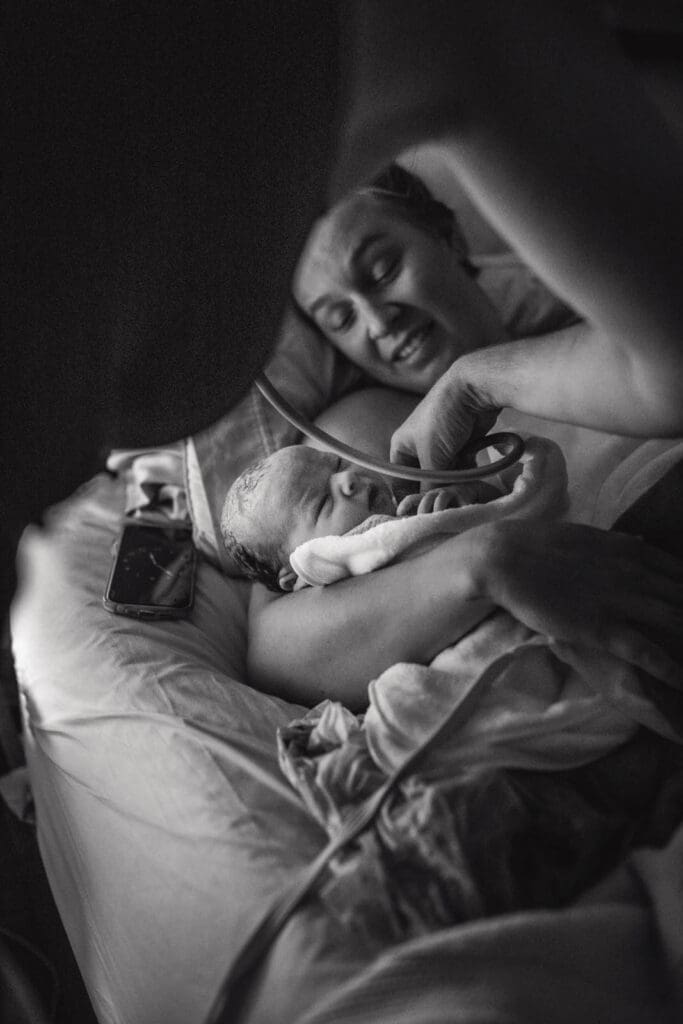 newborn exam in moms arms