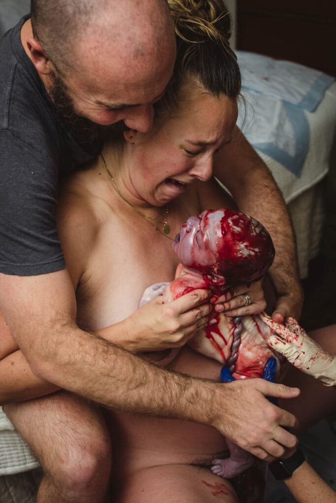 full of emotion, taking in baby as she is just born